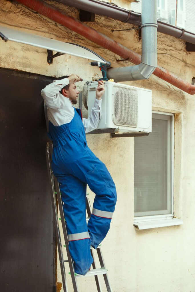 hvac-technician-working-capacitor-part-condensing-unit-scaled